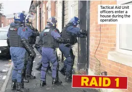  ??  ?? Tactical Aid Unit officers enter a house during the operation