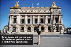  ??  ?? Syrian dancer and choreograp­her Yara Al-Hasbani performs a dance in front of Paris’ Opera Garnier.