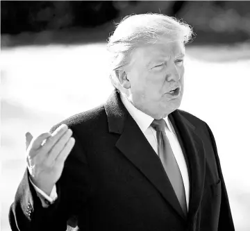  ?? — WP-Bloomberg photos ?? President Donald Trump speaks to members of the media before boarding Marine One on the South Lawn of the White House on Jan 5.