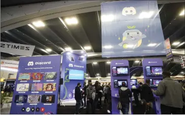 ?? JEFF CHIU — THE ASSOCIATED PRESS ?? Attendees play games while visiting the Discord booth at the Game Developers Conference 2023in San Francisco earlier this year. Extreme gamer chat rooms can be created on Discord or Steam without any oversight by the platform.