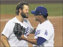  ?? KEITH BIRMINGHAM - THE ASSOCIATED PRESS ?? Clayton Kershaw, 22, of the Los Angeles Dodgers hugs Brusdar Graterol, 48, after defeating the Milwaukee Brewers 3- 0during Game 2of a National Leaguewild- card baseball series MLB baseball game at Dodger Stadium in Los Angeles on Thursday, October 1, 2020.