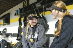  ?? VINCENT D. JOHNSON/DAILY SOUTHTOWN PHOTOS ?? Marian Catholic’s Nicole Paris, left, and Jensen talk in the dugout during practice in Chicago Heights on Monday.