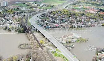  ?? CP ?? The Galipeault Bridge, a major artery connecting the island of Île-Perrot to the western tip of Montreal along Highway 20, was closed to traffic Sunday and Monday due to mounting water accumulati­on.