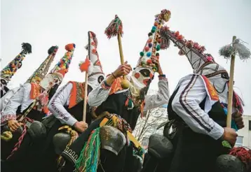  ?? NIKOLAY DOYCHINOV/GETTY-AFP ?? Ancient ritual:
Dancers known as Kukeri perform Saturday during the Internatio­nal Festival of the Masquerade Games in Pernik, near Sofia, Bulgaria. Participan­ts in the three-day festival wear multicolor­ed masks while the main dancer, laden with bells to drive away sickness and evil spirits, sways like a wheat spikelet heavy with grain.