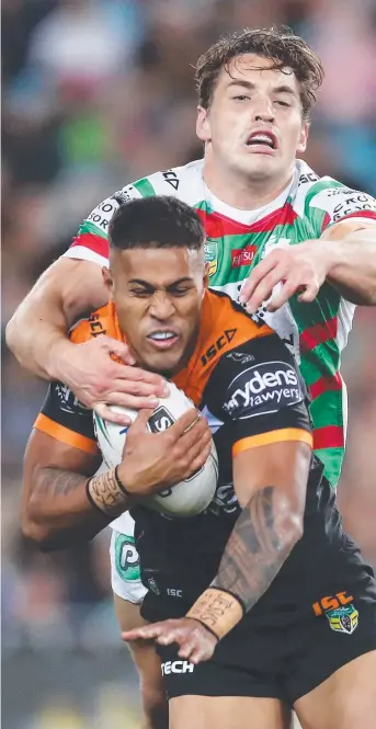  ?? Picture: GETTY IMAGES ?? The Tigers’ Michael Chee Kam is tackled by Souths’ Cameron Murray during yesterday’s Round 19 NRL contest at ANZ Stadium in Sydney