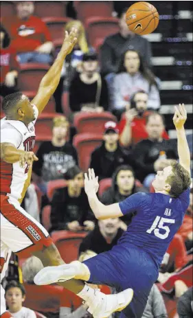  ?? BENJAMIN HAGER/LAS VEGAS REVIEW-JOURNAL ?? UNLV forwards Christian Jones, left, leaps to block a shot in the lane by Air Force’s Jacob Van on Saturday at the Thomas & Mack Center. Jones scored 15 points in the Rebels’ 87-85 double-overtime victory.