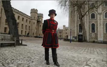  ?? Alastair Grant/Associated Press ?? The lack of tourists at the Tower of London, England’s top paid attraction, has been surreal for Amanda Clark, one of the tower’s famous resident guards known as Yeoman Warders or Beefeaters. She says she lives for interactin­g with people — directing tourists, telling them stories and posing with them for their selfies.