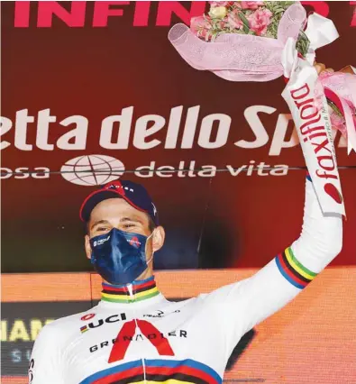  ?? (AFP) ?? Team Ineos rider Italy’s Filippo Ganna celebrates on the podium of the fourteenth stage of the Giro d’Italia 2020 race, a 34.1km individual time trial between Conegliano and Valdobbiad­ene yesterday.