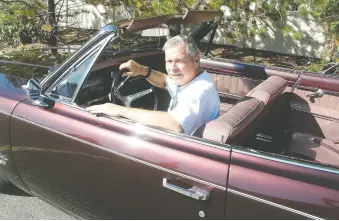  ??  ?? Ross Wylie behind the wheel of the Rambler ragtop he bought from his father in 1975 for $1.