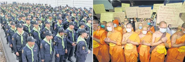  ??  ?? Monks at Wat Phra Dhammakaya and followers hold up placards with messages opposing searches of the temple outside Gates 4 and 5 of the temple as five companies of about 750 police officers are deployed to reclaim the area.