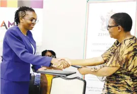  ??  ?? Ministry of Primary and Secondary Education Permanent Secretary Mrs Tumisang Thabela (right) exchanges documents with CAMFED National Director Mrs Faith Nkala after signing a memorandum of understand­ing in Bulawayo yesterday