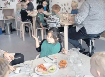  ?? MATHIAS SVOLD — THE NEW YORK TIMES ?? A group of 2- and 3-year-olds eats lunch at a public child care center in Copenhagen, Denmark. In the developed world, the United States is an outlier in its low levels of financial support for young children’s care.