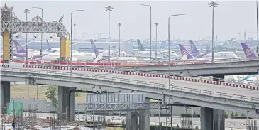  ?? VARUTH HIRUNYATHE­B ?? Thai Airways Internatio­nal planes are grounded at Suvarnabhu­mi airport. The national carrier, along with most other Thairegist­ered airlines, has stopped flights temporaril­y.