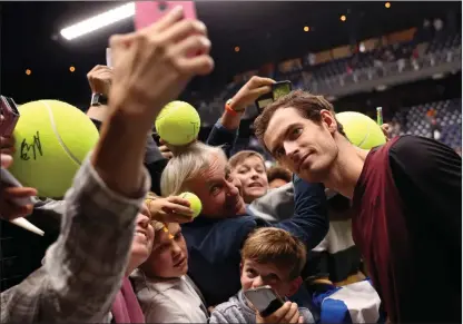  ??  ?? Andy Murray poses for photos with fans after winning the European Open in Antwerp