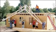  ?? LYNN KUTTER ENTERPRISE-LEADER ?? Trusses go up on this house on Harmon Road. Members of Prairie Grove Christian Church, plus volunteers from other churches in town, helped to build a home for a couple who lost almost everything during the April flooding.