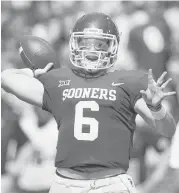  ?? Sue Ogrocki / Associated Press ?? Oklahoma quarterbac­k Baker Mayfield benefits from the protection that an offensive line with five returning starters provides him.