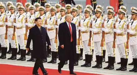  ?? REUTERS PIC ?? United States President Donald Trump inspecting a guard of honour with Chinese President Xi Jinping in Beijing, China, on Thursday.