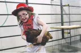  ??  ?? Lorelei Seibold, from Denver, is all smiles after showing the judge her Rhode Island Red. The National Western Stock Show returns Jan. 7-22. Denver Post file