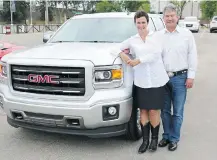  ?? Stuart Gradon/Calgary Herald ?? Lottery winner Laura MacMillan and her fiancé, Perry Kopec, stand with part of the Kinsmen GMC Truck and Toys Package.