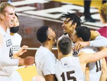  ?? RICKKINTZE­L/THE MORNING ?? Lehigh players swarm teammate Marques Wilson, 11, after he hit the game-winning 3-point shot at the buzzer in overtime to defeat Lafayette 90-89 Saturday at Stabler Arena in Bethlehem.
CALL