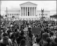  ?? JACQUELYN MARTIN / ASSOCIATED PRESS FILE (2022) ?? People gather June 24, 2022, outside the Supreme Court in Washington following the justices’ decision to overturn Roe v. Wade.