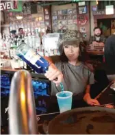  ?? GETTY IMAGES ?? Bartender Ming Ling waits on customers Sunday at Sluggers, a family-owned sports bar and grill in the shadow of Wrigley Field.