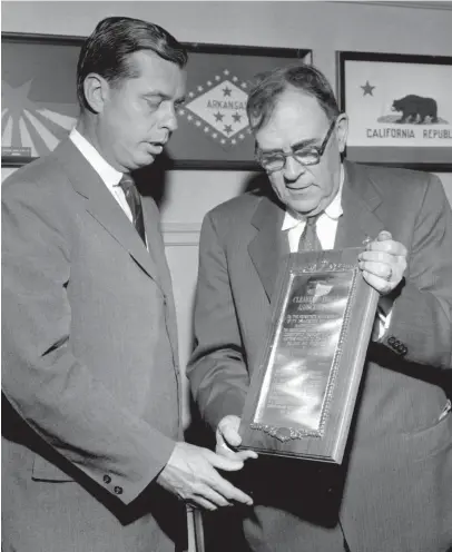  ?? THE COMMERCIAL APPEAL ?? Seventy years of service to the community by the Memphis Clearing House was recognized on May 20, 1954, by the Chamber of Commerce when Col. Roane Waring, right, president of the chamber, presented Allen Morgan, left, president of the Clearing Associatio­n, a bronze plaque.