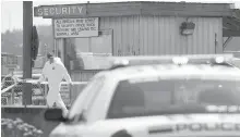  ?? JONATHAN HAYWARD, THE CANADIAN PRESS ?? RCMP officers are seen outside the Western Forest Products mill in Nanaimo on April 30, 2014.