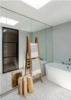  ??  ?? Opposite page: Backlit display shelves add to the cosy ambience of the media room; mirrors and glass panels expand the sense of space in this bathroom