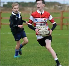  ??  ?? Fleet-footed Malachaí Kirwan evades the opposition before going on to score a try in the Pobalscoil Chorca Dhuibhne v. Mercy Mounthawk under-16 rugby match at Carraig on Wednesday last. Photo by Declan Malone