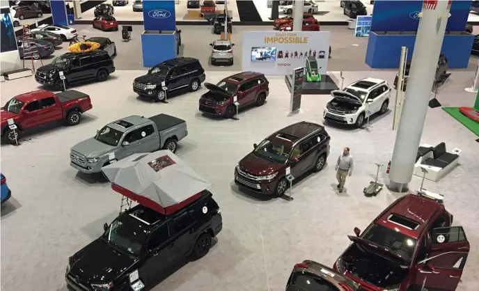  ?? CHRISTOPHE­R EVANS PHOTOS / HERALD STAFF ?? MORE ON THE FLOOR: An array of cars, trucks and SUVs await the public on the eve of the New England Internatio­nal Auto Show at the Boston Convention &amp; Exhibition Center in the Seaport.