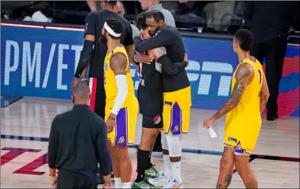  ?? Photo/Ashley Landis
AP ?? Los Angeles Lakers’ LeBron James (second from right) hugs Portland Trail Blazers’ Gary Trent Jr. (2) after an NBA basketball first round playoff game on Saturday in Lake Buena Vista, Fla.
