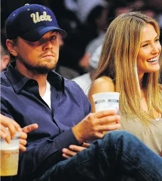  ?? KEVORK DJANSEZIAN/GETTY IMAGES ?? Leonardo DiCaprio and girlfriend model Bar Refaeli sit courtside during an NBA playoff game in Los Angeles in April 2010. For DiCaprio, given his talent, wealth and fame , finding younger women to date doesn’t appear to be a problem. That’s not the...