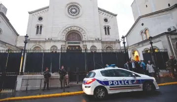  ?? (Reuters) ?? ARMED OFFICERS stand in front of a synagogue in Marseille, France.