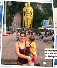 ??  ?? Elliot checks out a Buddha in Malaysia