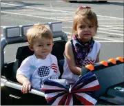  ??  ?? LEFT, TOP: Colten (left) and Cabela Leat pilot a kiddie-sized car in the July Fourth parade.