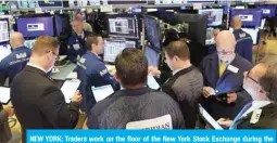  ??  ?? NEW YORK: Traders work on the floor of the New York Stock Exchange during the opening bell on Tuesday in New York. —AFP