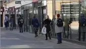  ?? KIRSTY WIGGLESWOR­TH — THE ASSOCIATED PRESS ?? People use social distancing to prevent the spread of coronaviru­s, as they queue to enter a supermarke­t in Windsor, England.