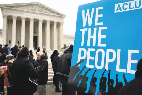  ?? Jacquelyn Martin / Associated Press ?? People rally in January outside the U.S. Supreme Court against Ohio’s voter roll purges during arguments in the case.