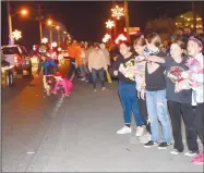  ?? Westside Eagle Observer/MIKE ECKELS ?? Kids of all ages go after candy thrown from a passing float during the Decatur Chamber of Commerce’s annual Christmas parade through downtown Decatur Friday night.