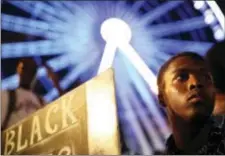  ?? BRANDeN CAMP - tHe ASSoCiAteD PReSS ?? A demonstrat­or holds a sign during a protest in Atlanta on Friday in response to the police shooting deaths of terence Crutch in tulsa, okla. and Keith lamont Scott in Charlotte, N.C.