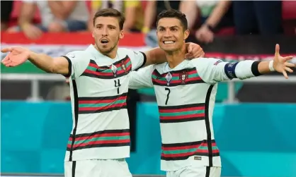  ??  ?? Cristiano Ronaldo (right) celebrates with Rúben Dias after scoring Portugal’s third goal against Hungary. Photograph: Hugo Delgado/EPA