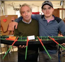  ??  ?? The father and son team of Breandán and Nikolai Ó Conchúir with one of their prize-winning model naomhóga at the West Kerry Show on Sunday. Photo by Declan Malone