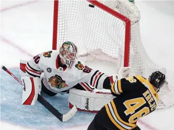  ?? MATT STONE / BOSTON HERALD ?? OPEN AND SHUT CASE: David Krejci fires the puck past Blackhawks goalie Collin Delia during the third period of the Bruins’ 6-3 victory against the Blackhawks last night at the Garden.