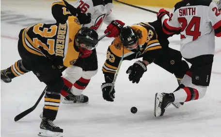  ?? NAncy LAne / HeRALd STAFF ?? PUCK BATTLE: It was a rough and tumble evening for the Bruins against the Devils yesterday at TD Garden.