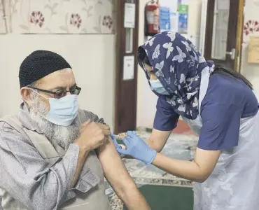  ??  ?? VACCINE: People receive their first Covid-19 vaccinatio­n jabs at Elland Masjid (mosque)