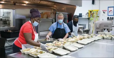  ?? PHOTO SUBMITTED BY TEDDY WINGERT ?? Capuchin Soup Kitchen volunteers put together meals for those in need.