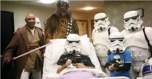  ??  ?? The masked patient and his son were joined by characters from the movies