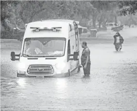  ?? TREVOR HUGHES/USA TODAY ?? An ambulance is trapped on a flooded street Thursday, the second day of heavy rains, in McAllen, Texas. “The latest Texas rainfall totals are astounding,” said Weather Channel meteorolog­ist Greg Diamond.