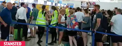  ??  ?? Wait for take-off: Passengers seek informatio­n from staff after flights were cancelled at the Essex airport STANSTED